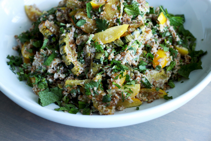 delicata squash + whole lime tabbouleh // The First Mess A 3/4 angle shot of a delicata squash and lime bulgur salad in a wide white bowl. The salad also contains tomatoes and herbs.