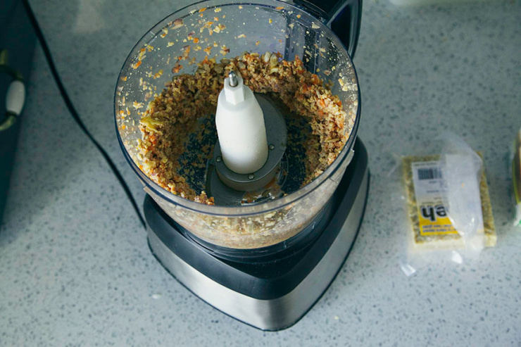 An overhead image shows a tempeh veggie burger mixture coming together in a food processor.