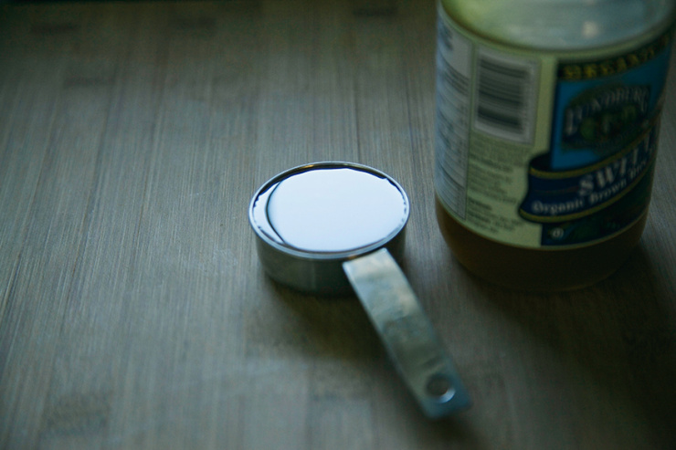 A 3/4 angle shot shows a measuring cup filled with brown rice syrup.