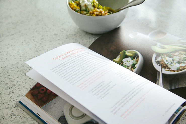 A 3/4 angle shot shows a cookbook open on a countertop.