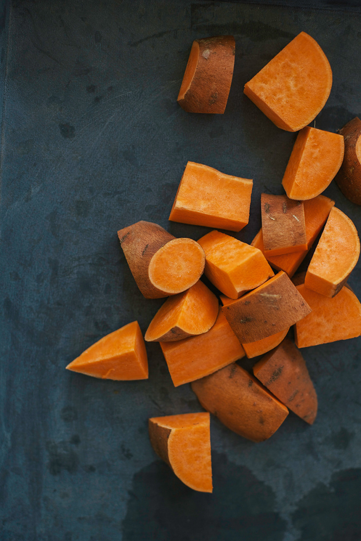 An overhead shot of diced sweet potatoes with the skin on.