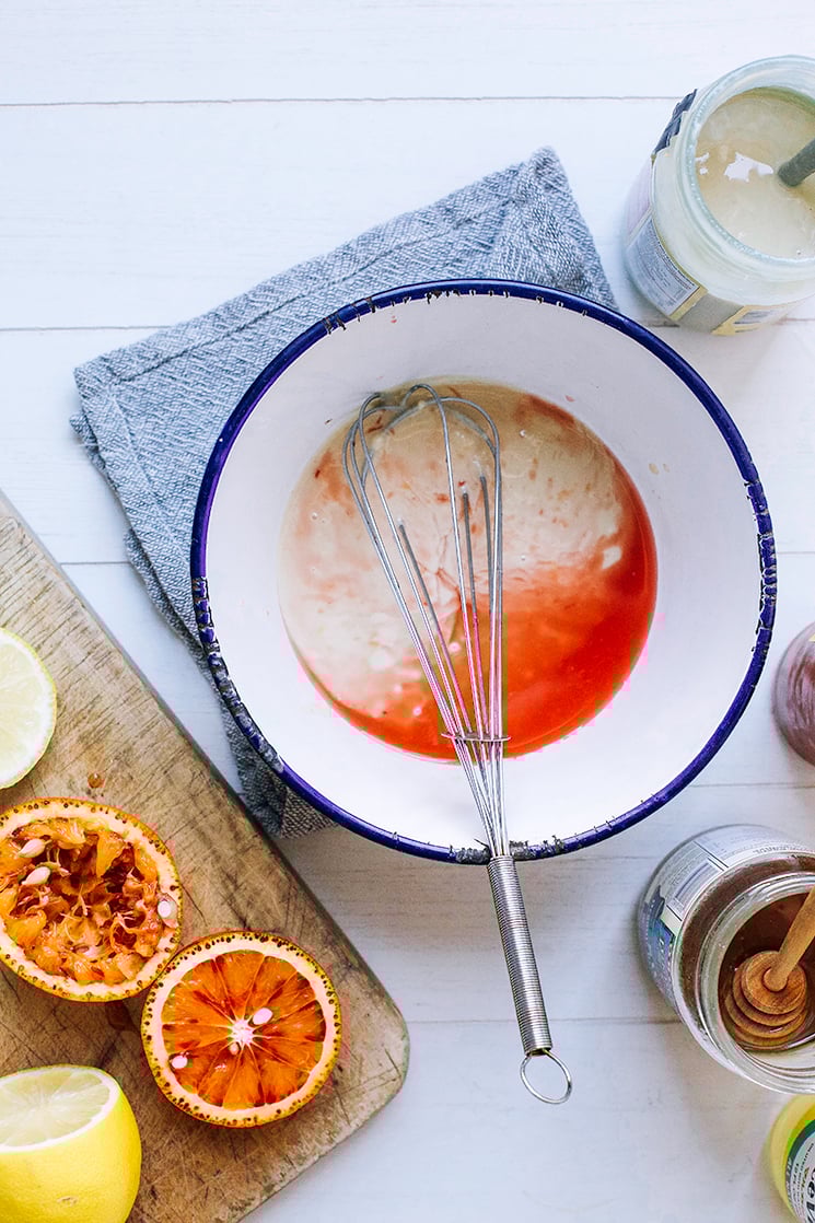 overhead shot shows tahini dressing coming together in a bowl