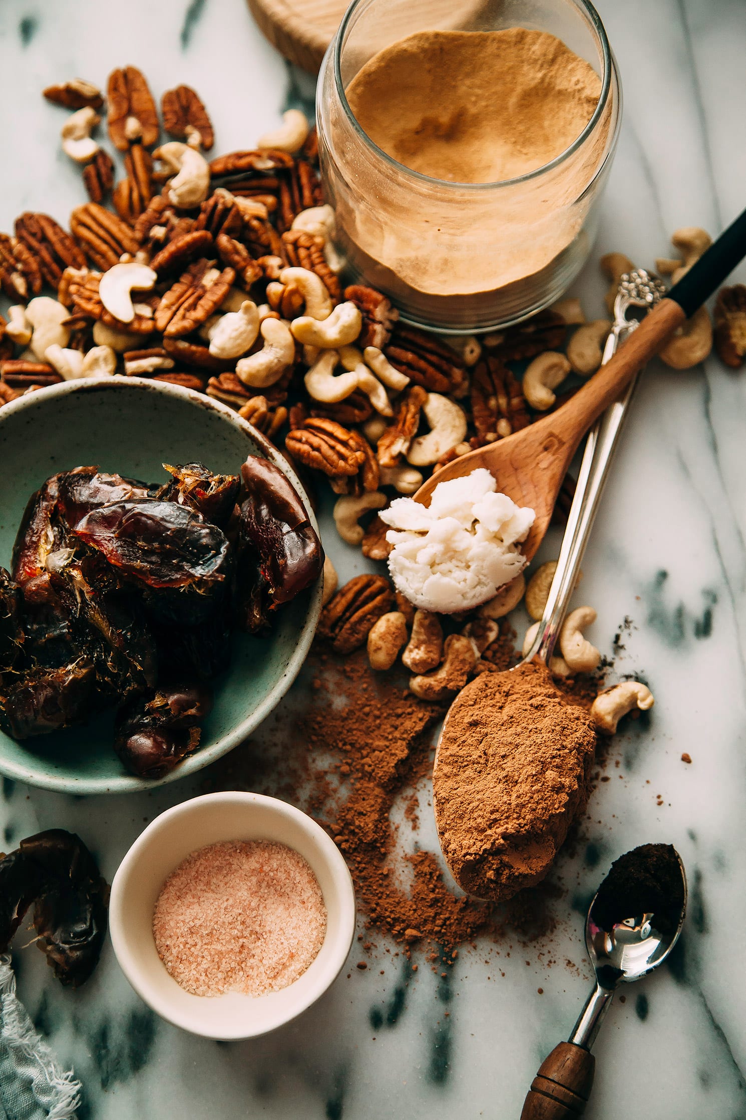 An overhead shot of ingredients used for superfood brownie bites on a marble background.