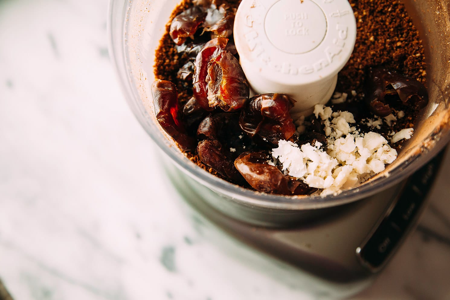 An overhead shot of ingredients in the bowl of a food processor.