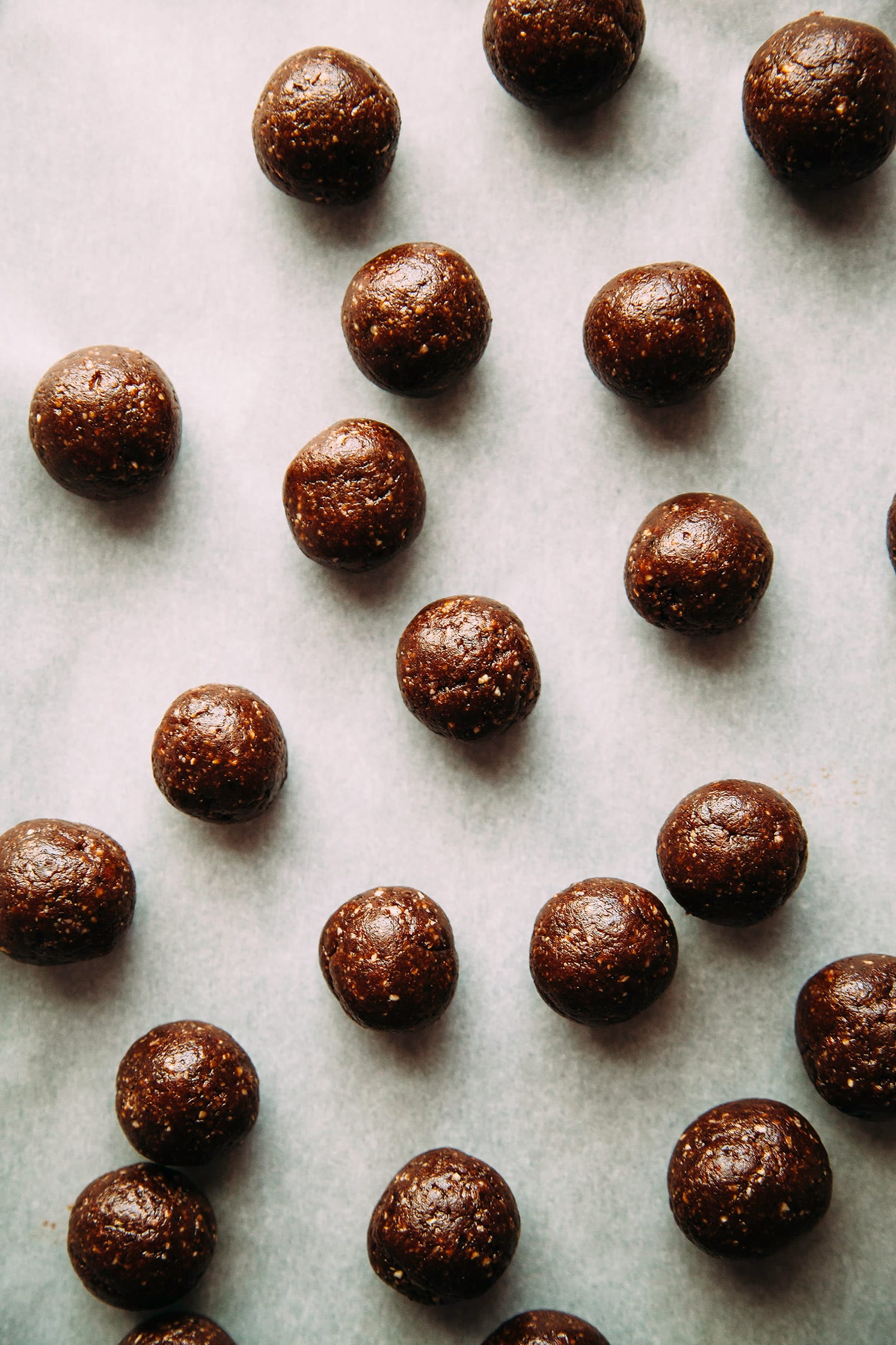 An overhead shot of rolled up, dark brown raw truffles.