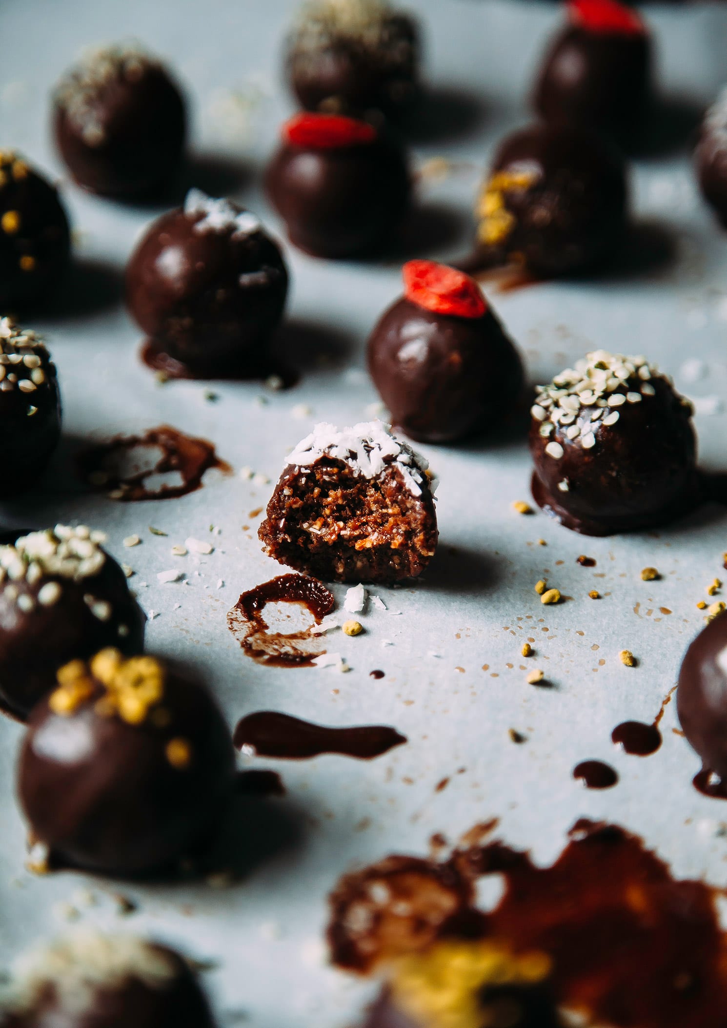 A 3/4 angle shot of superfood brownie bites. One is bitten into and shows a gooey interior.