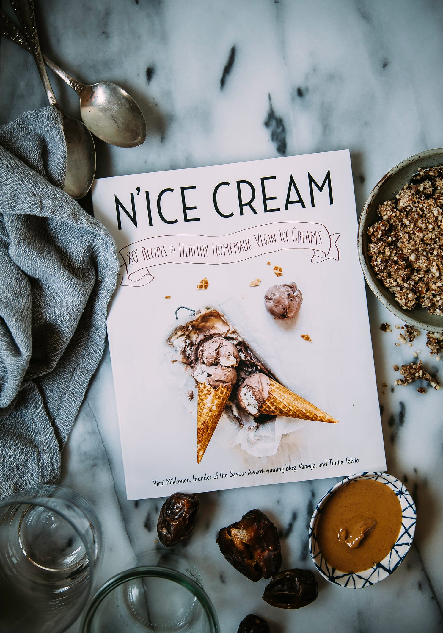 An overhead shot of the NICE CREAM Cookbook on a marble background