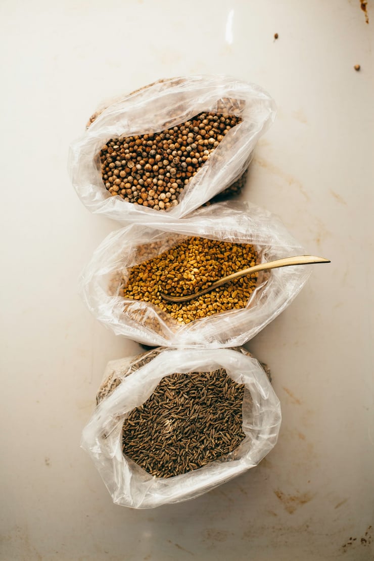 An overhead shot of whole spices in zipper seal bags.