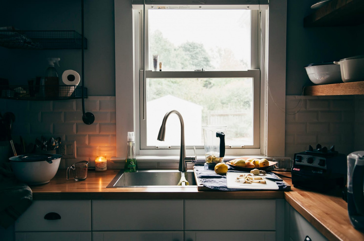 A cozy kitchen scene lit by a candle.