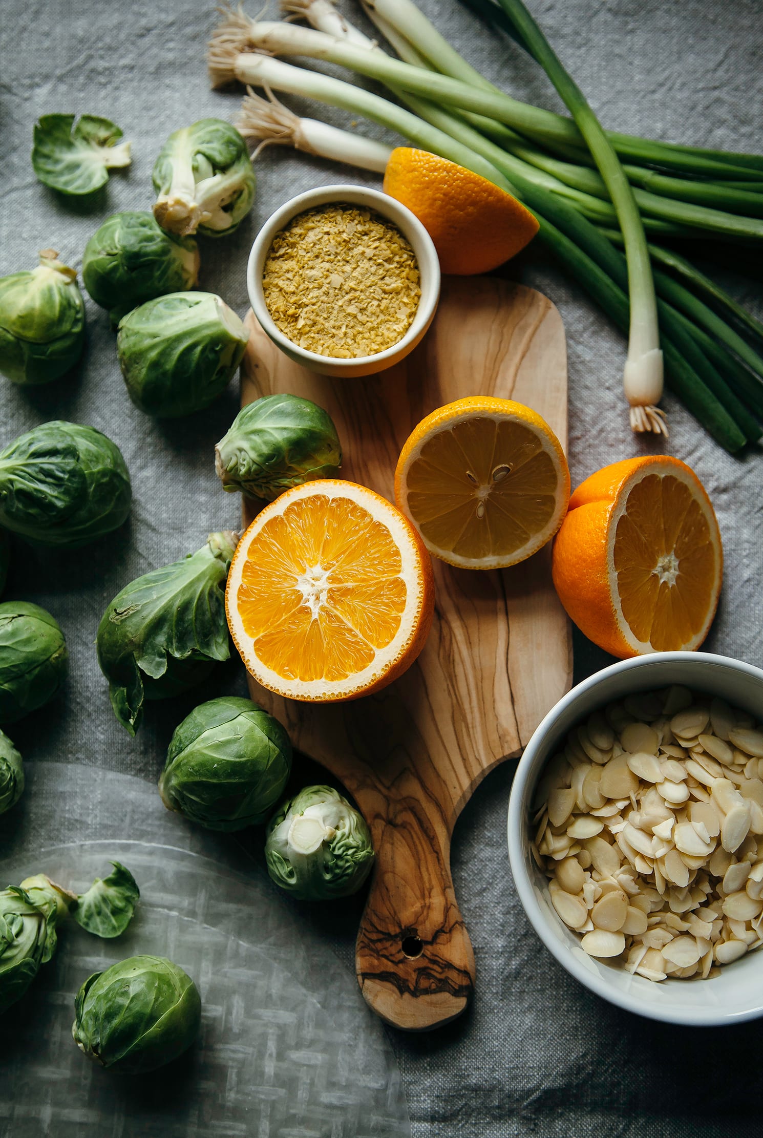 An overhead shot of ingredients for a citrus brussels sprouts slaw.
