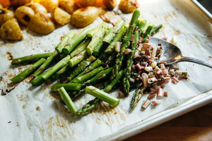 An overhead shot of roasted mixed vegetables on a baking sheet.