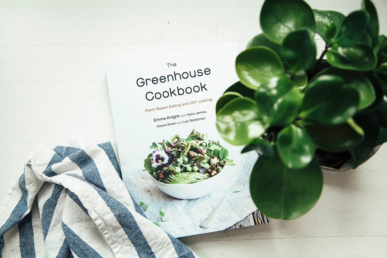 An overhead shot of The Greenhouse Cookbook on a white background.