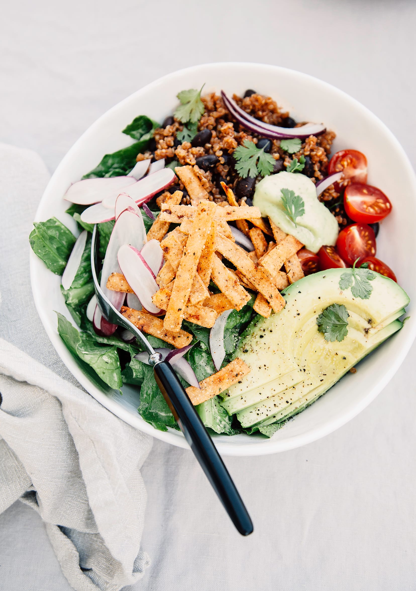 Fresh Taco Salads from "Love Real Food" (vegan recipe) An overhead shot of a taco salad in a white bowl.