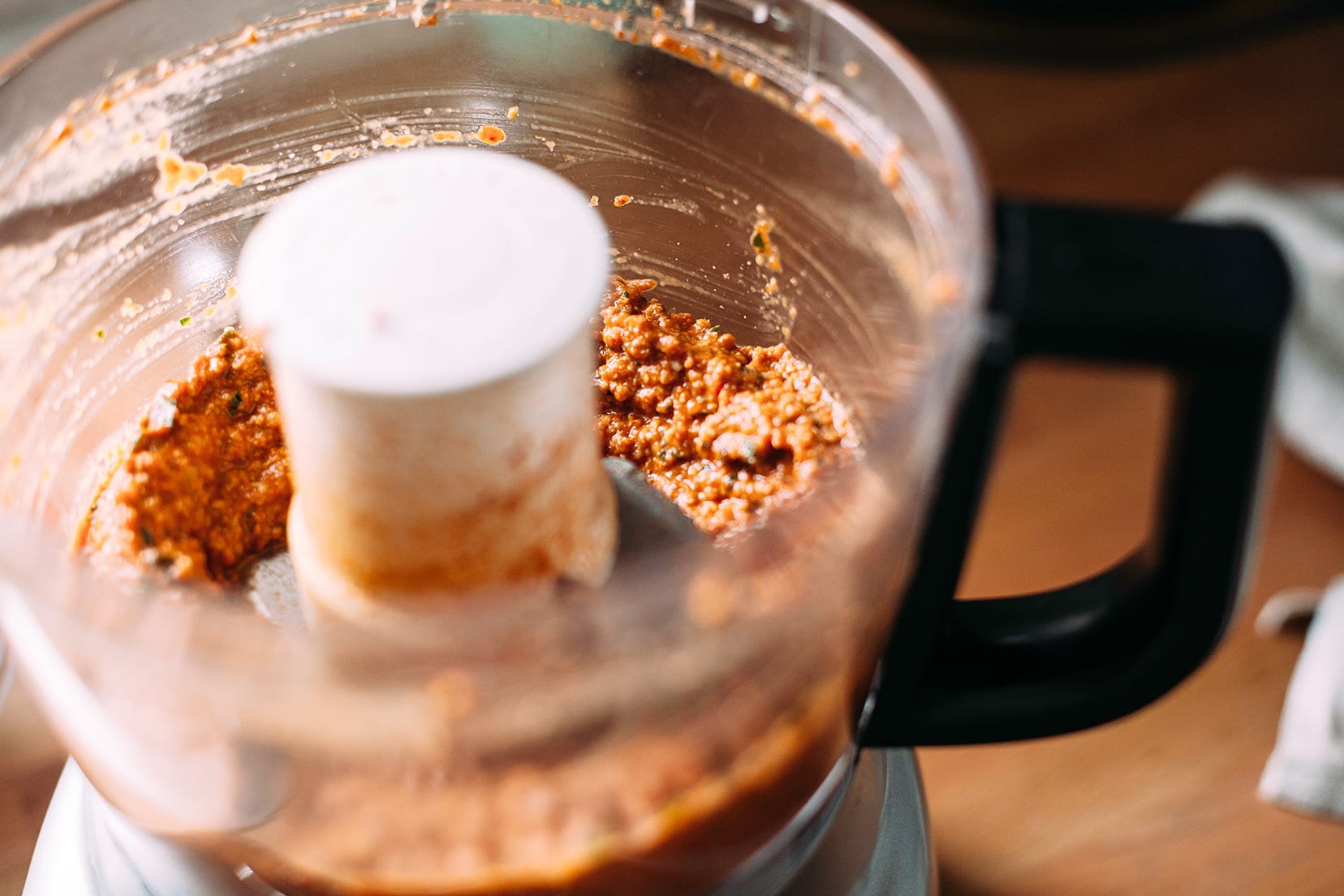 Image shows sunflower romesco sauce being whipped up in a food processor.