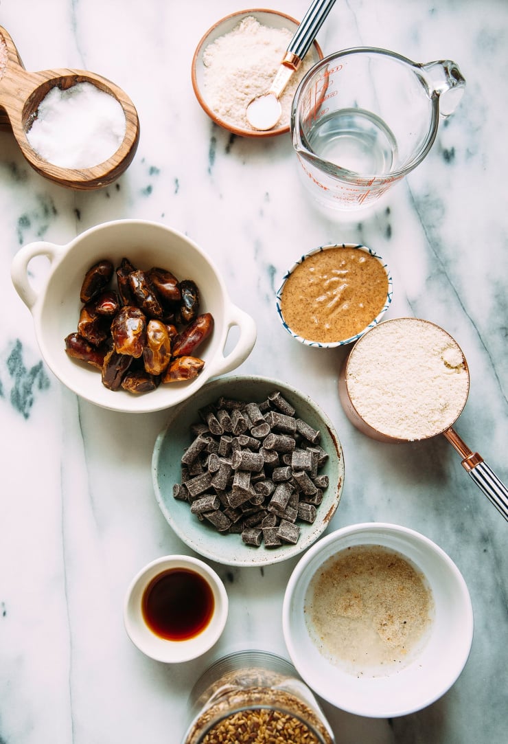 An overhead shot of ingredients for cookies on a white/grey marble background.