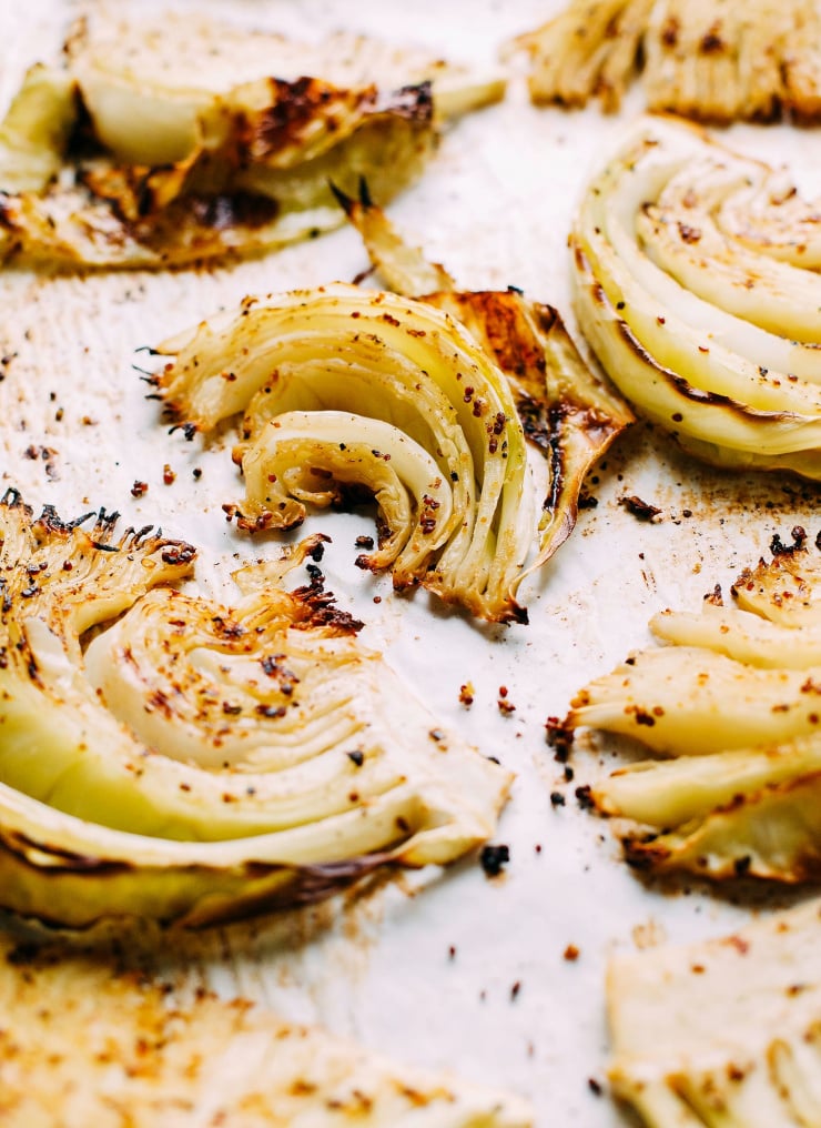 A 3/4 angle shot of roasted cabbage wedges with crispy edges.