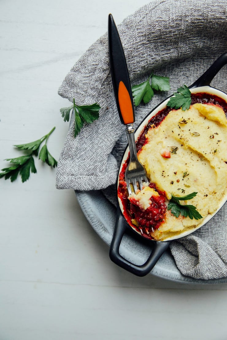 An overhead shot of an individual pot pie topped with mashed potatoes.