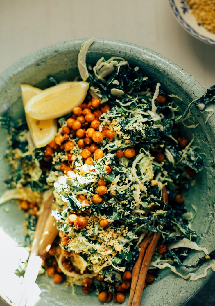 An overhead shot of a shredded kale and Brussels sprout salad with a creamy dressing