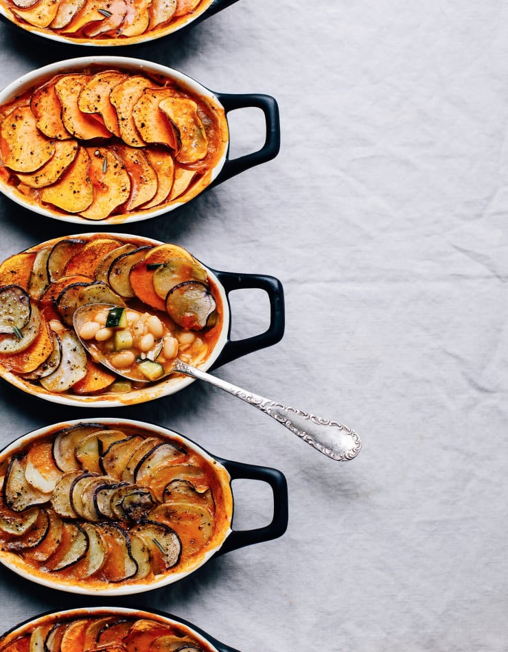 An overhead shot of individual vegan casseroles. Part of a roundup of vegan holiday recipes