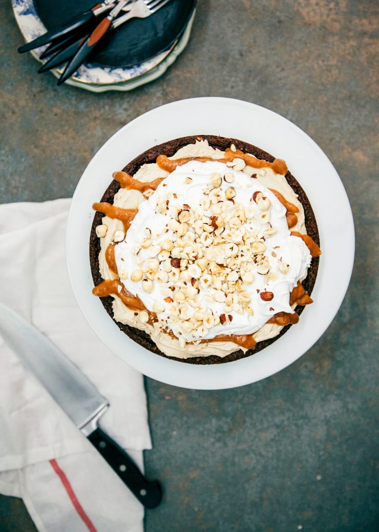 An overhead shot of a vegan chocolate hazelnut torte, drizzled with vegan caramel.