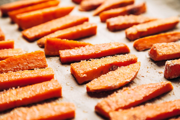 Up close images shows par-baked sweet potato fries.