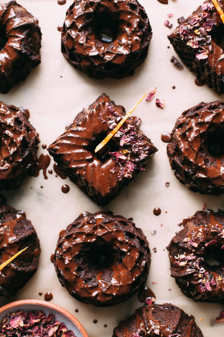 An overhead shot of a bunch of mini chocolate Bundt cakes with chocolate glaze.