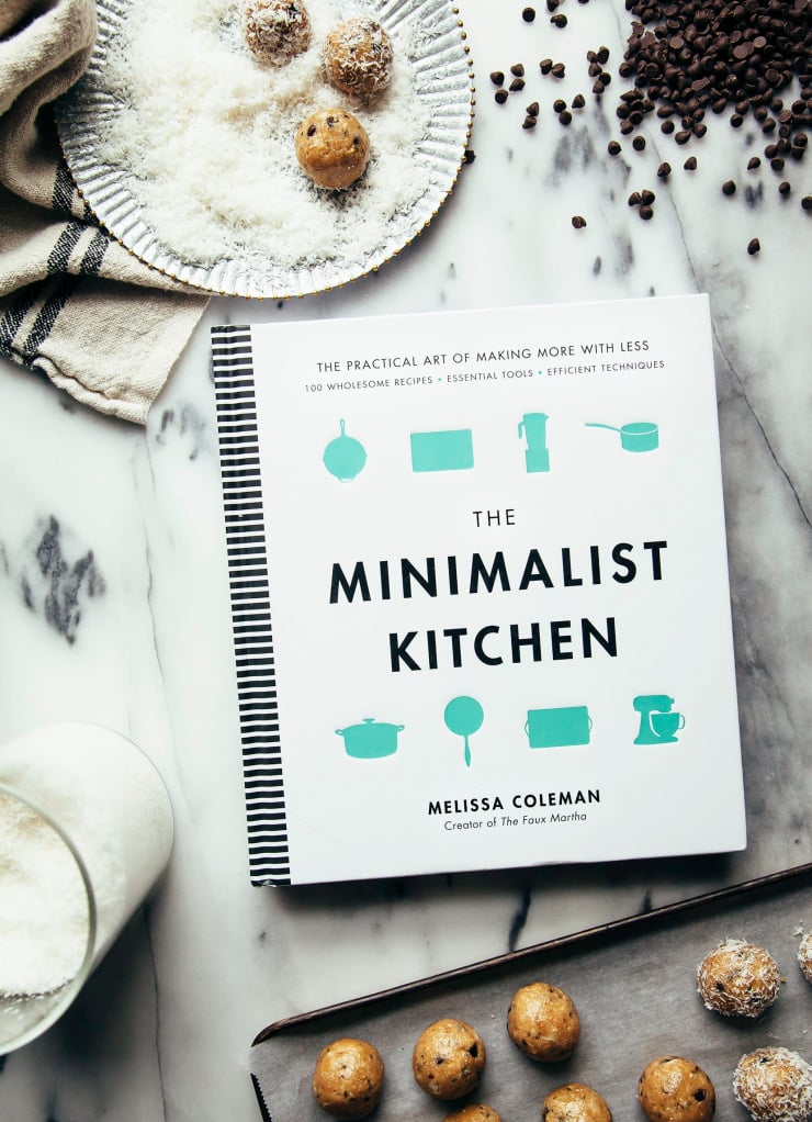An overhead shot of "The Minimalist Kitchen" cookbook on a marble background.