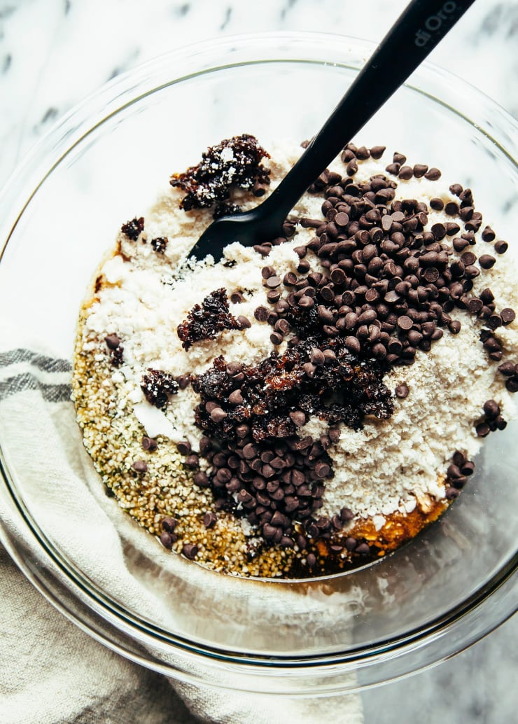 An overhead image of the dry ingredients for oatmeal cookie bites being stirred together in a bowl.