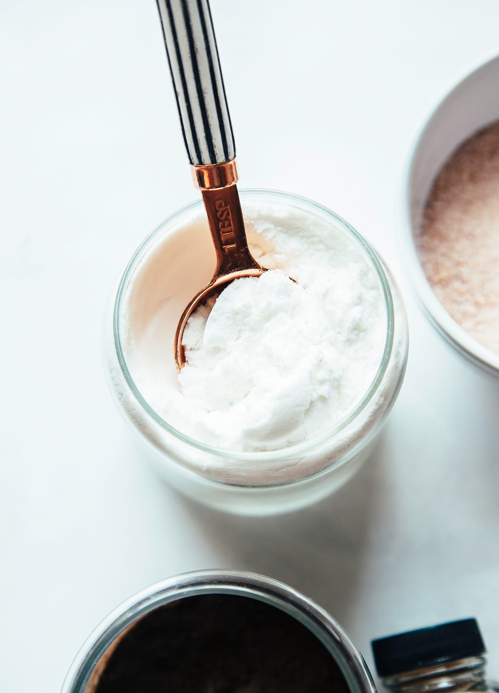 Image shows a spoon in a jar of coconut milk powder.