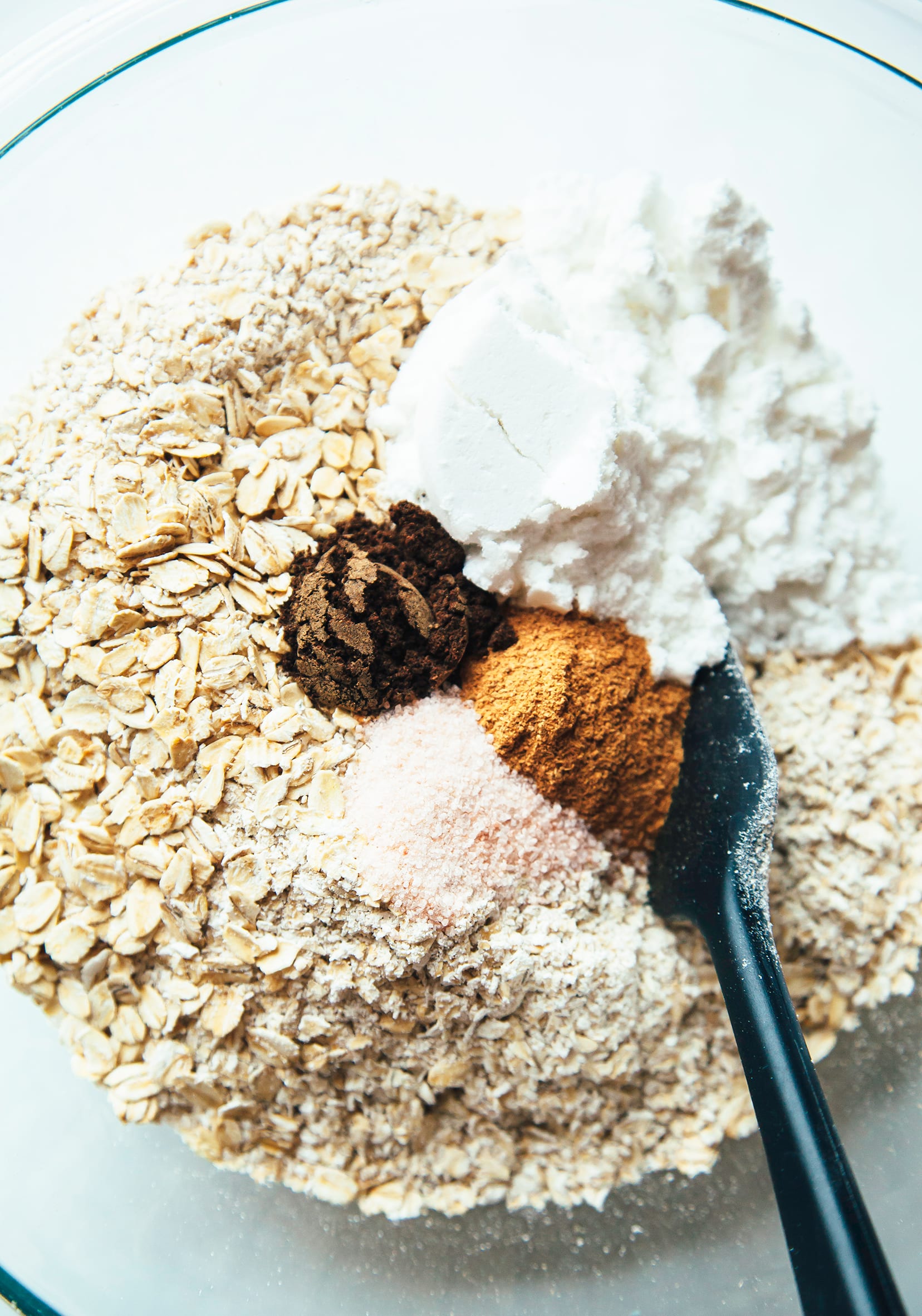 Overhead shot of oats and spices in a bowl, before being stirred together.
