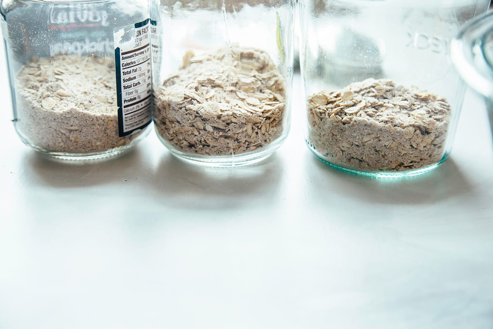 Image shows DIY instant oatmeal mixture packed into jars.