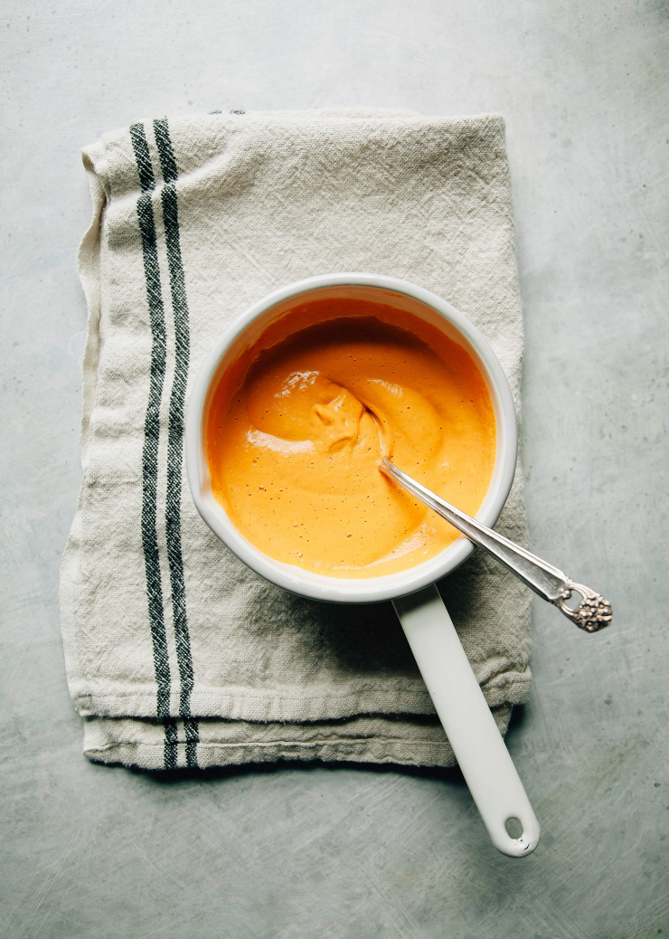 An overhead shot of a blended, super creamy cheesy roasted red pepper sauce.
