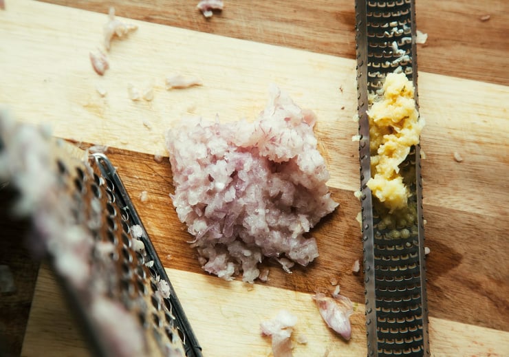 An overhead shot of grated shallots and garlic.