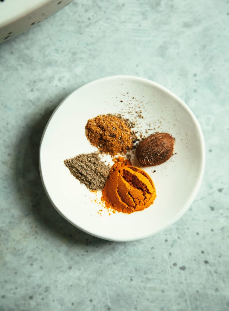 An overhead shot of spices in a small white bowl.