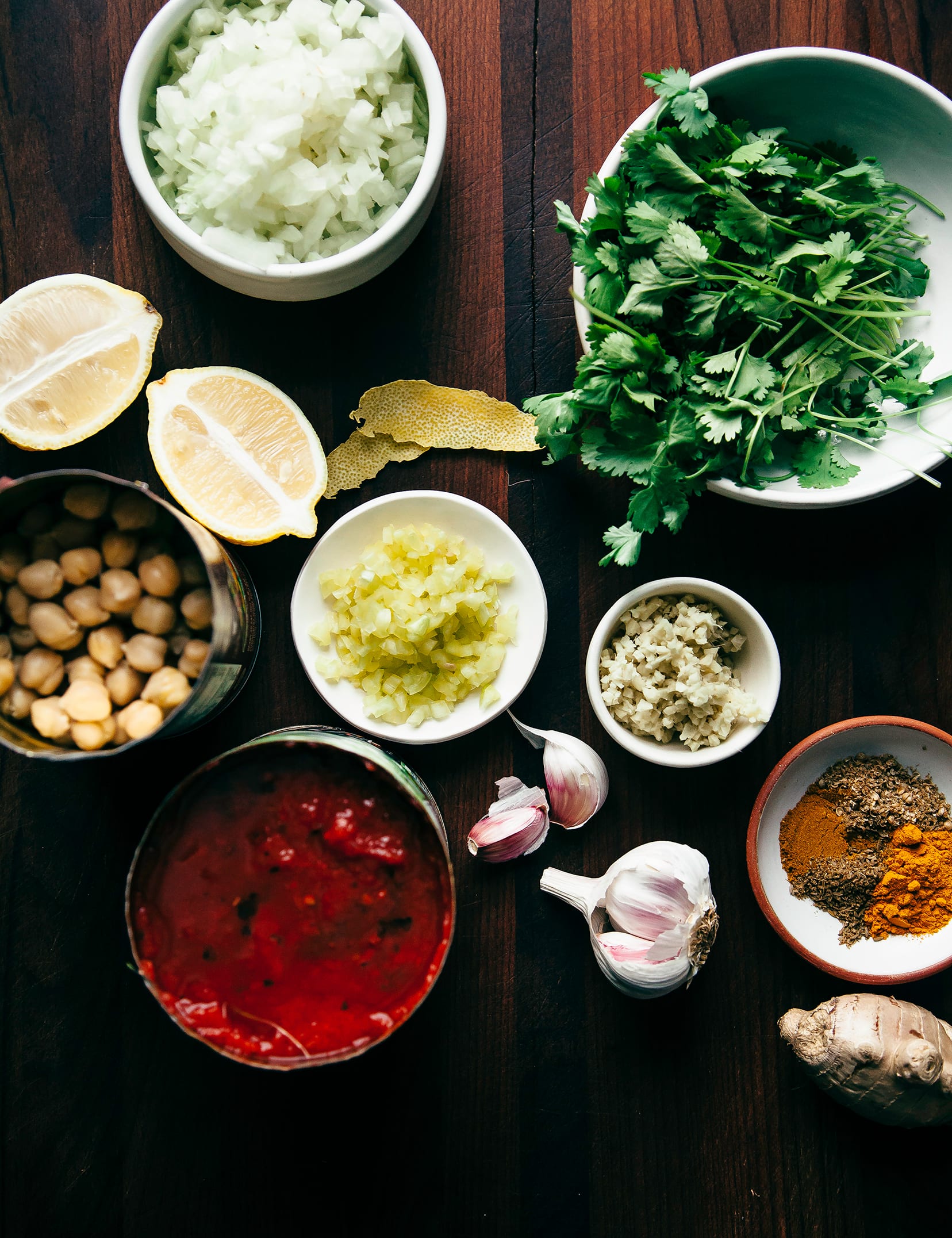An overhead shot of prepped ingredients in bowls for making Chana masala.
