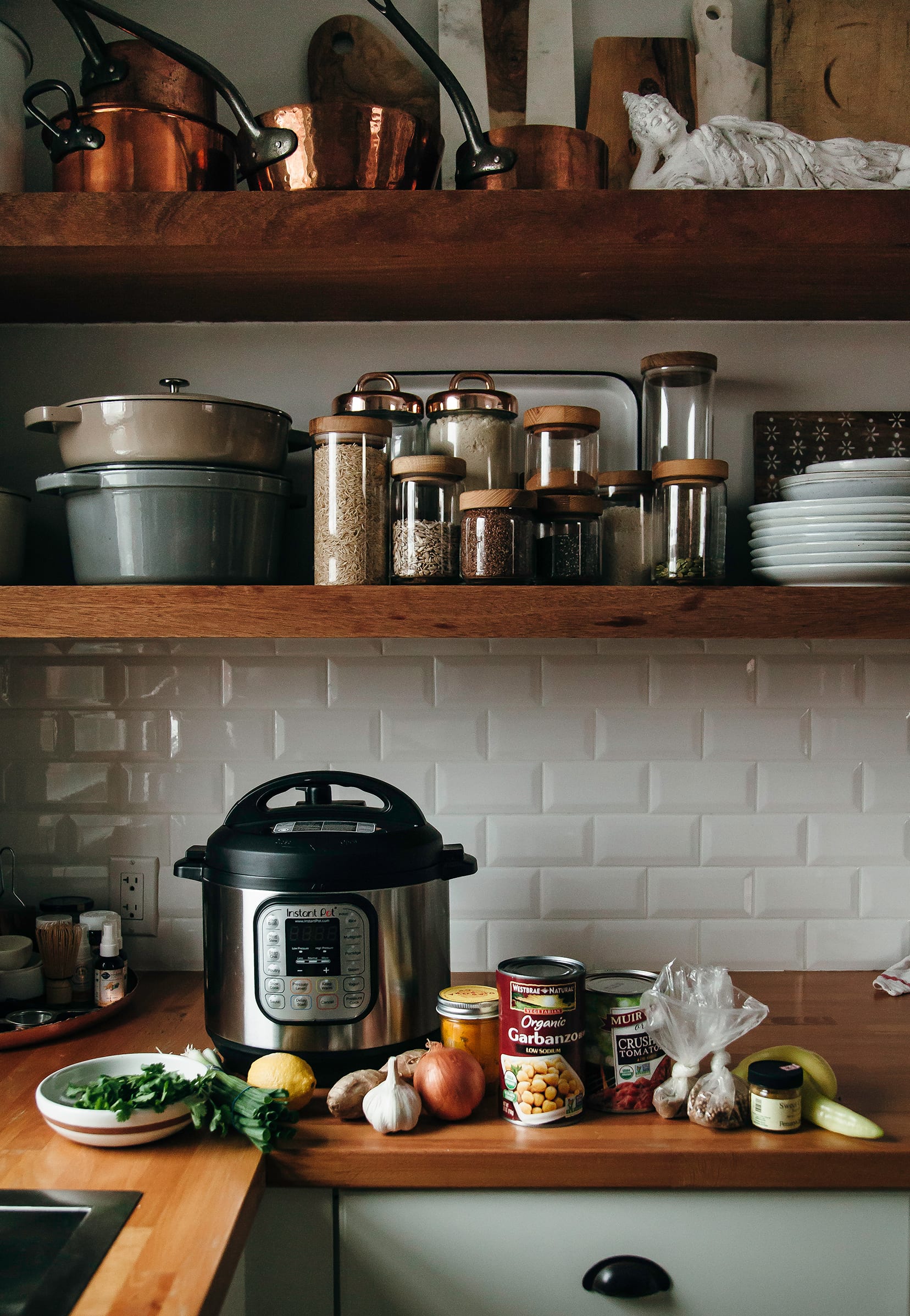 Image shows a kitchen scene with soup ingredients on the counter along with an Instant pot.
