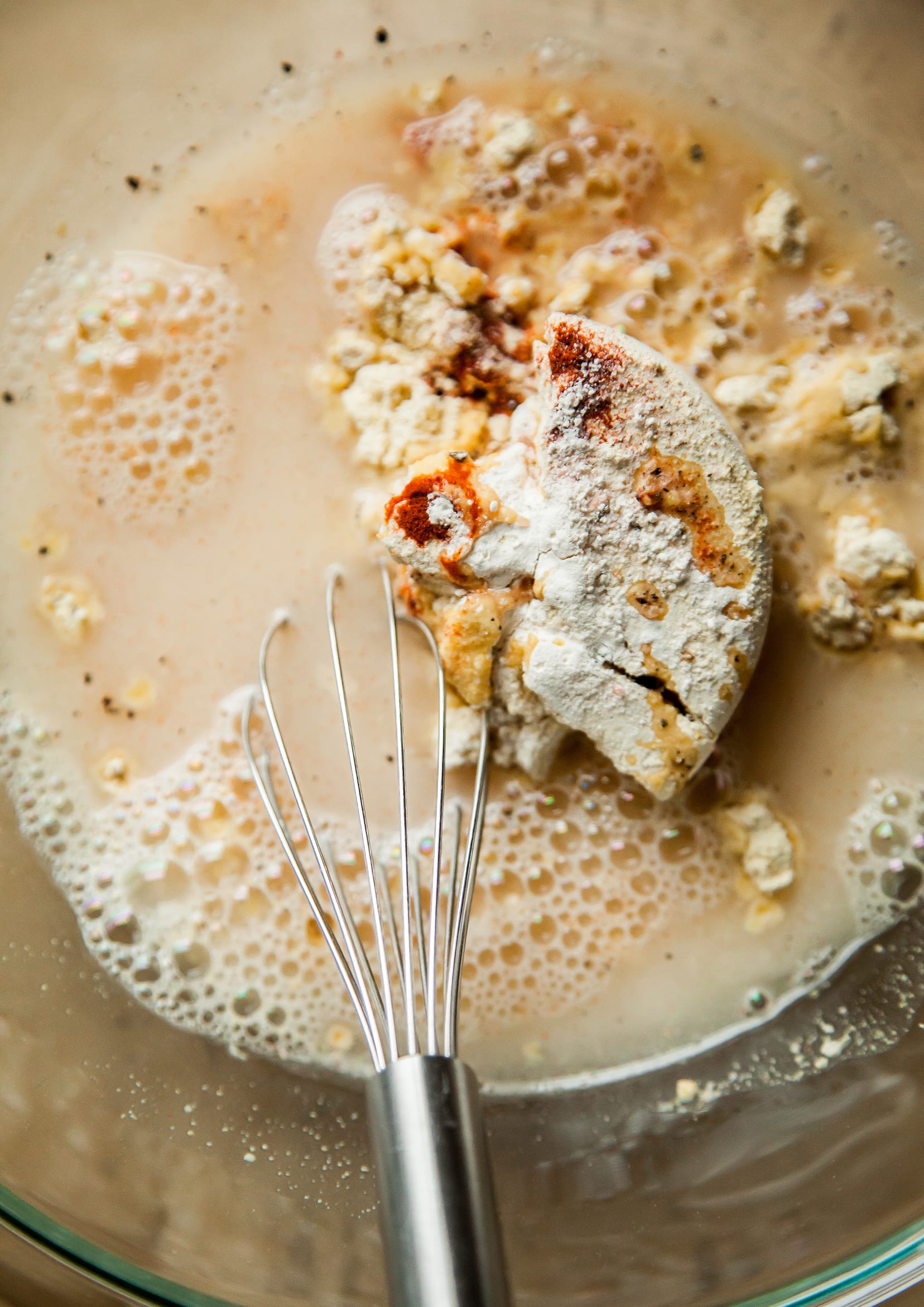 Image shows flour and water being whisked into a batter.
