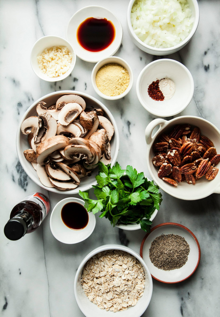 An overhead shot of ingredients for vegan meatballs on a marble background.