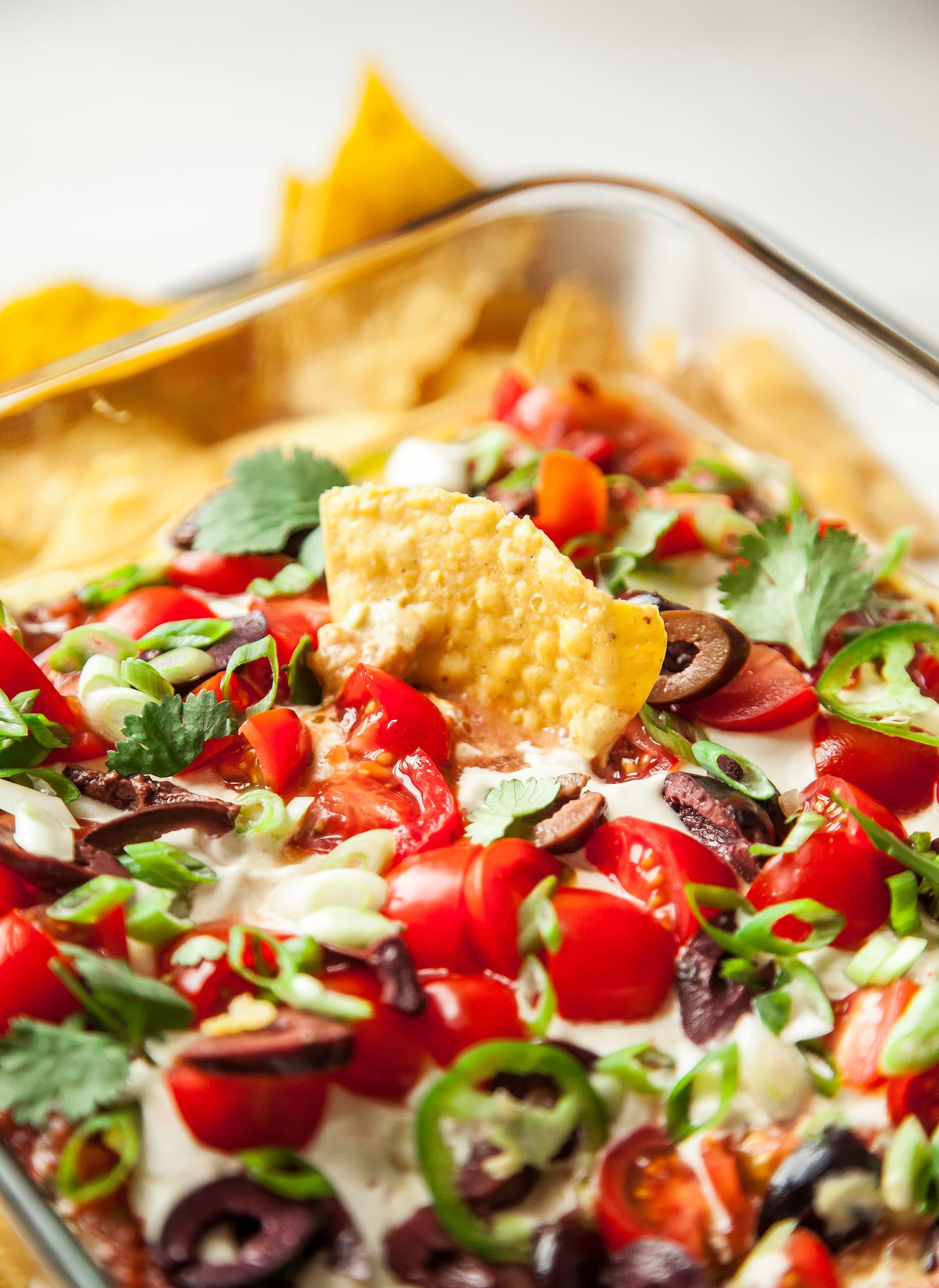 An overhead shot of a vegan seven layer dip with chips.