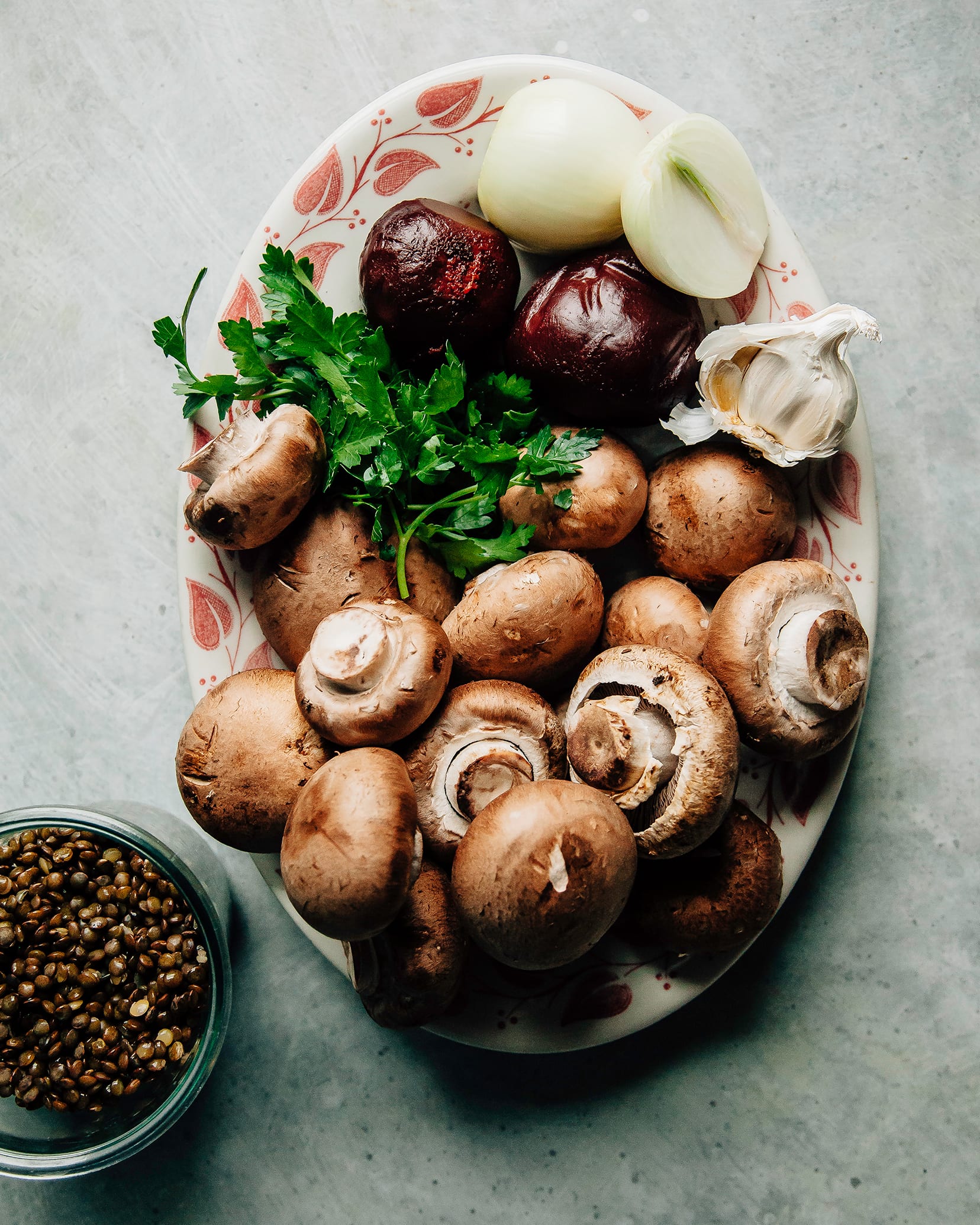 An overhead shot of raw ingredients needed for a vegan bolognese on a platter.