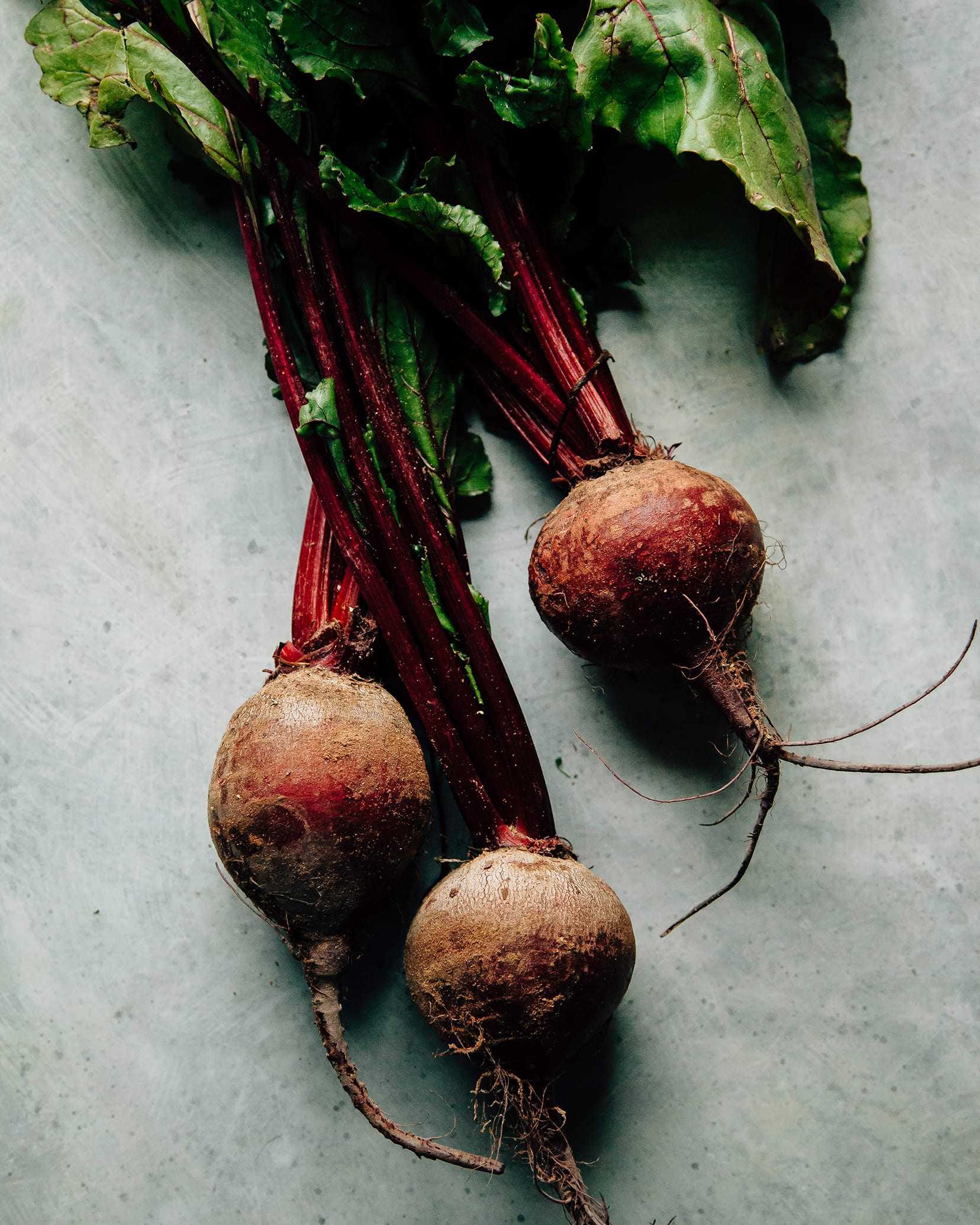 An overhead shot of some fresh beets with greens attached.