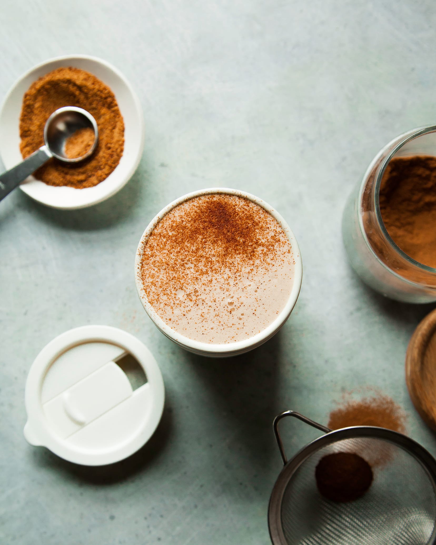 Overhead shot of a frothy tea latte in a to-go mug.