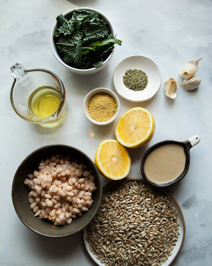 Overhead image of ingredients used for a creamy kale pesto dip.