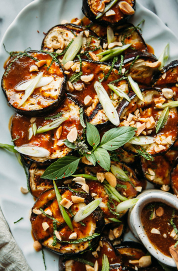 Image shows finished plating of a grilled eggplant dish with peanut butter teriyaki sauce.