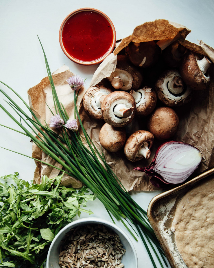 An overhead shot of ingredients for a mushroom flatbread.