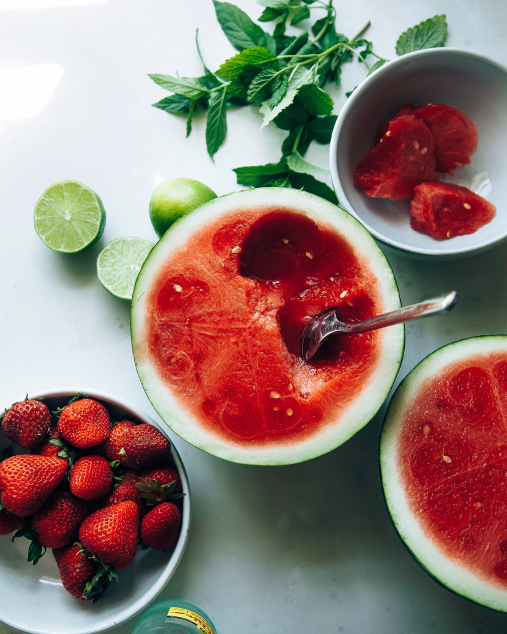 An overhead shot of ingredients used for sparkling strawberry watermelon limeade.