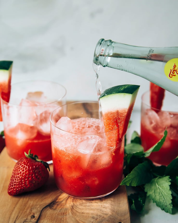 Photo displays sparkling strawberry watermelon limemade being topped with sparkling water.