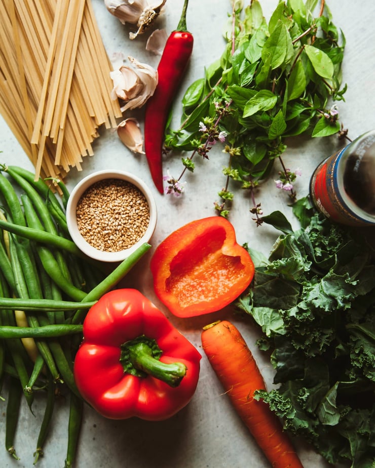 An overhead shot of ingredients for a vegan Thai basil noodle dish.