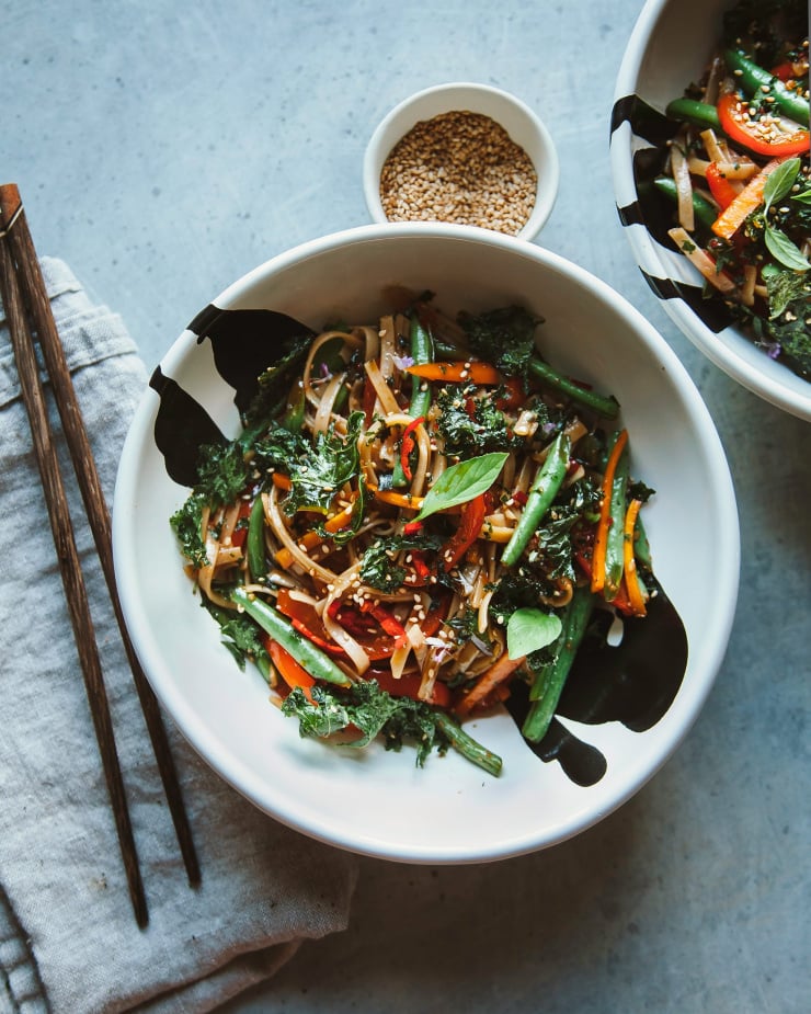 Overhead shot of veggies and noodles in a bowl.