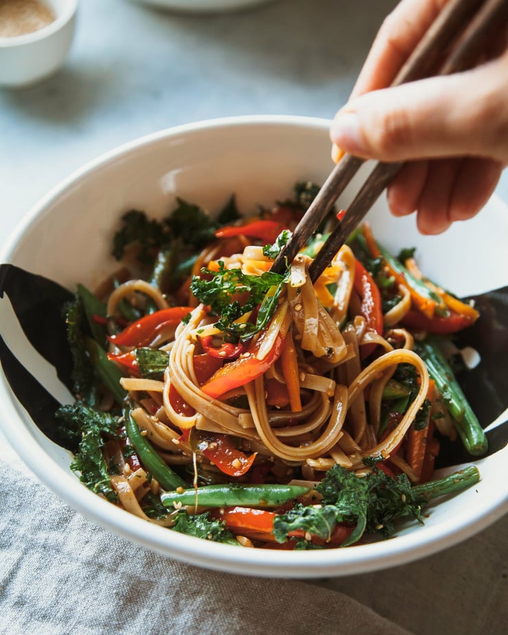 Image shows a single serving of a vegan Thai basil noodle dish.